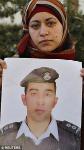 Anwar Tarawneh holds a photo of her husband Lt. Muath al-Kaseasbeh, before he was burned alive by ISIS.